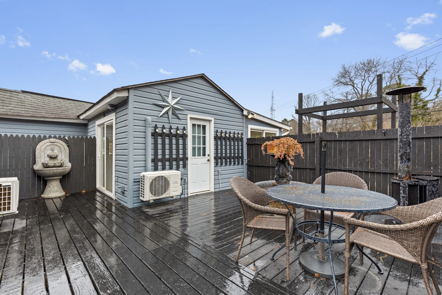 Older photo of the fenced deck and outdoor table