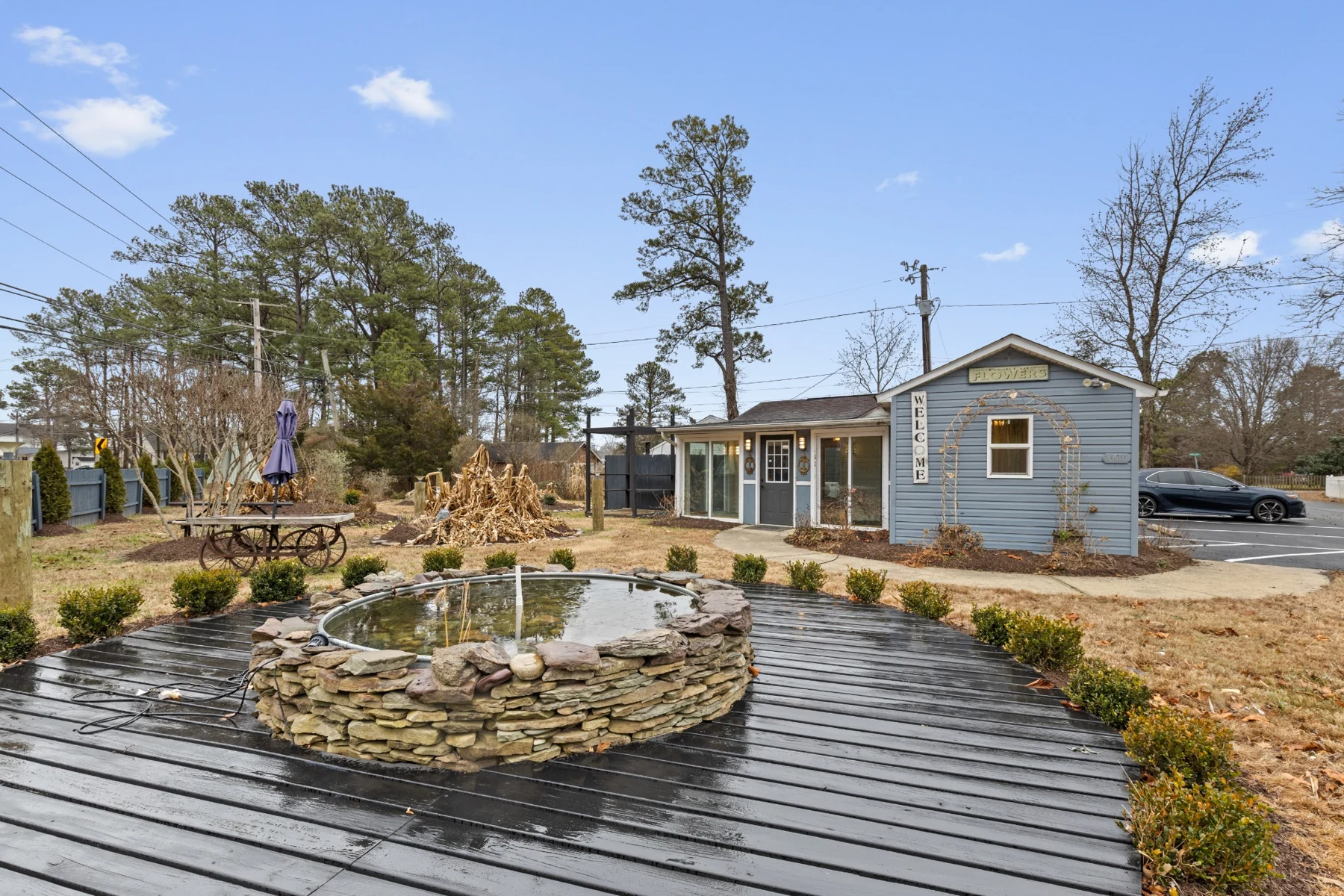 Older photo of the property exterior, garden, and stone pond